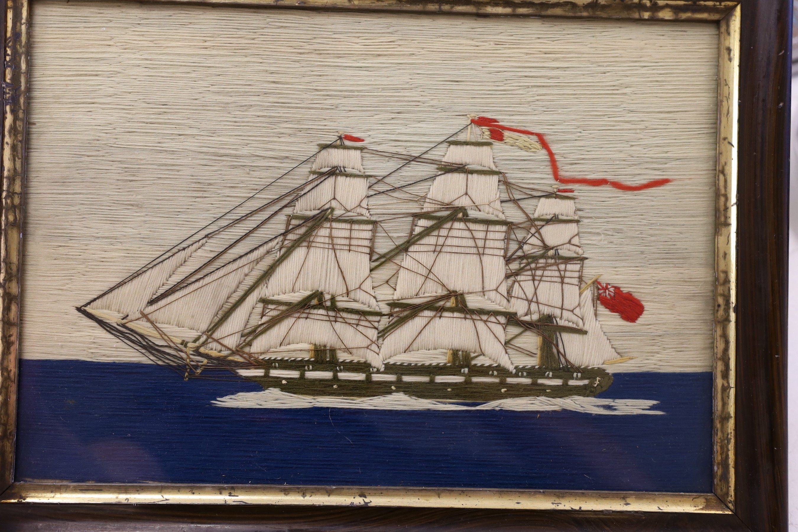 A pair of woolwork ship portraits, HMS Birmingham and Russian Warship Peresviet, a smaller woolwork of a sailing boat and a Berlin woolwork of a biblical scene, HMS Birmingham: 49cms wide x 39cm high